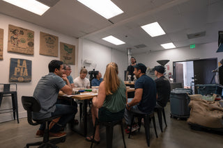 Group of people in a coffee tasting class in the roastery room.
