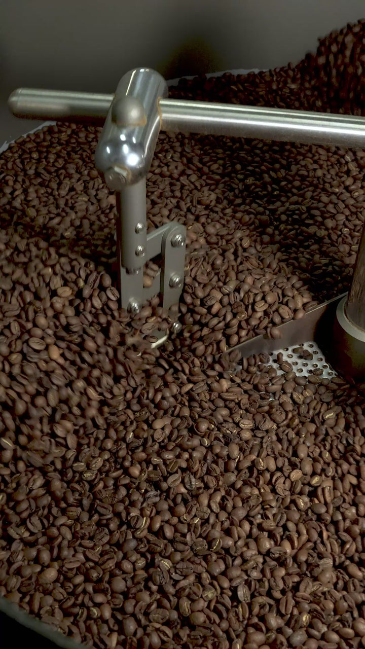 Roaster cooling down beans in a drum.